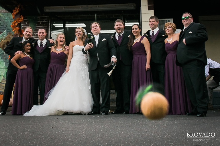 A cork flies at the camera as the wedding party pops open a bottle of champagne