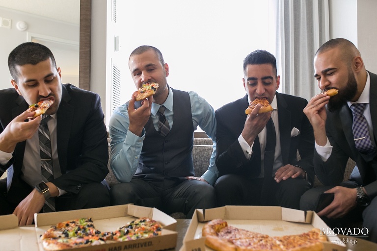 Groomsmen enjoying pizza before wedding 