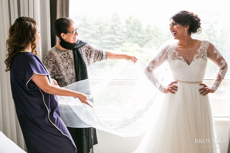 Bride getting ready with the help of her mother