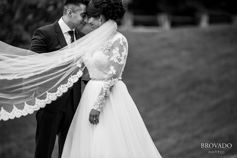 Dramatic black and white photo of bride and groom on their wedding day