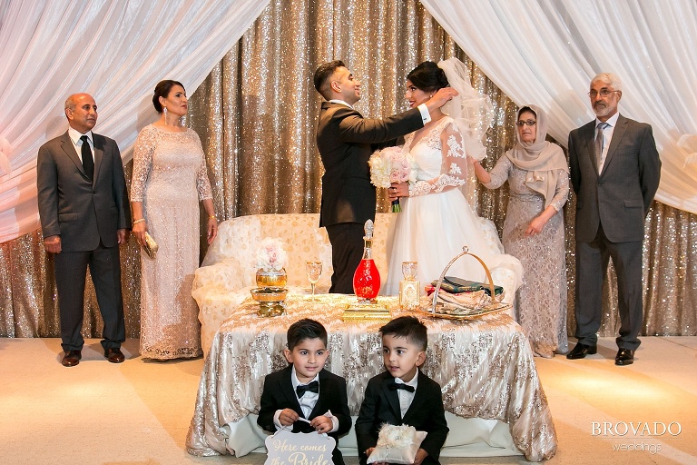 Groom removing bride's veil