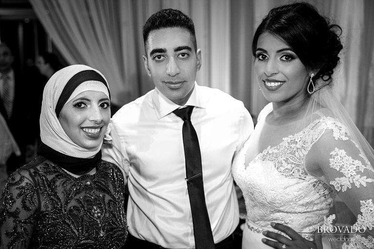 Bride and groom with reception guest