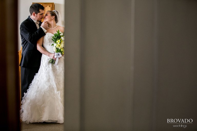 Heidi and Tony kissing through church doors