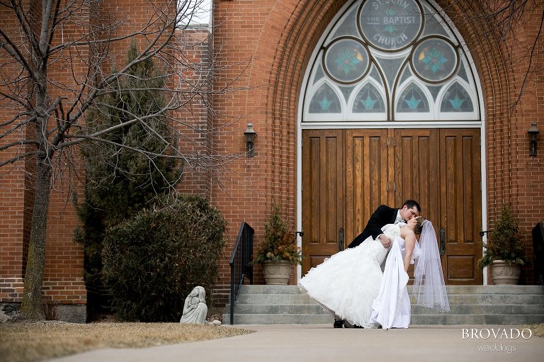 Groom dipping bride in front of Monticello baptist church