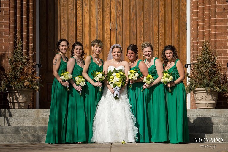 Bridesmaids in green dresses smiling with Heidi