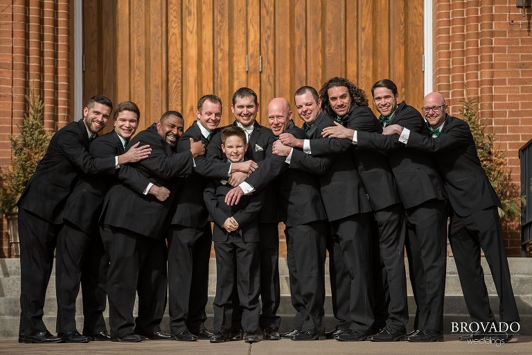 Groomsmen hugging the groom