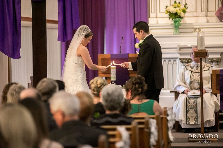 Bride and groom lighting unity candle