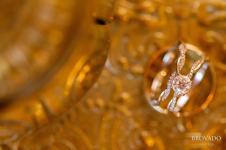 Closeup of wedding rings against gold backdrop