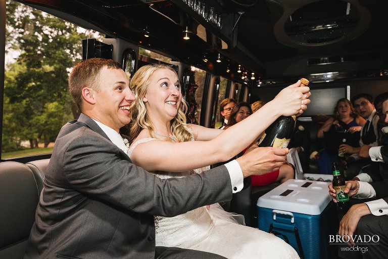 Brooke and Aaron popping champagne on party bus