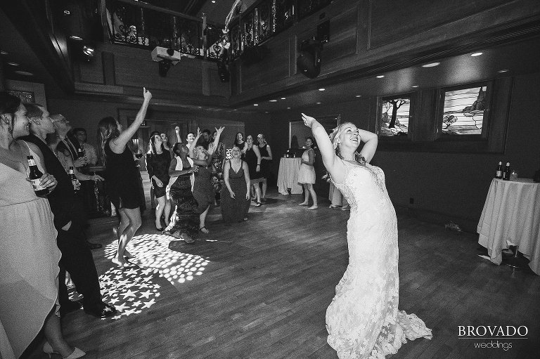 Brooke throwing her bouquet over her shoulder