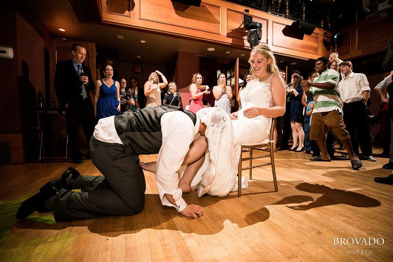 Aaron pulling garter off of bride