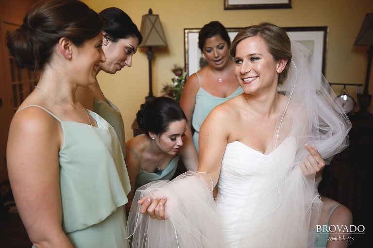 Bridesmaids helping Annie put her veil on