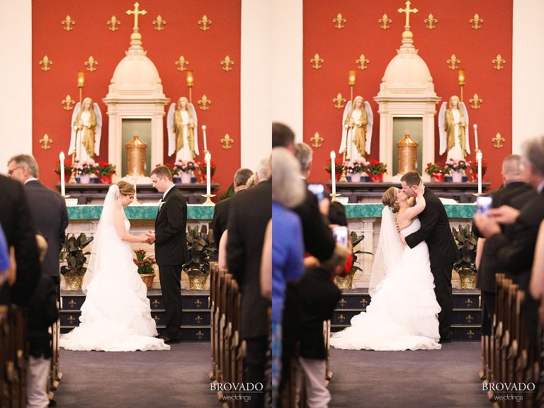 Bride and Groom kissing at the altar