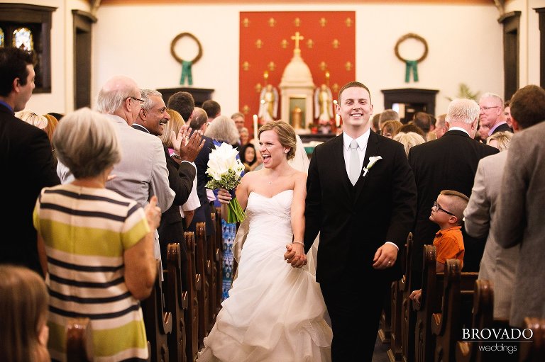 Annie and Tyler cheering while walking down the aisle