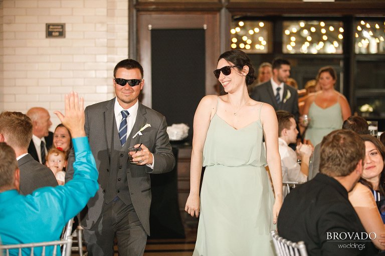 Bridesmaid and groomsmen wearing sunglasses during grand entrance