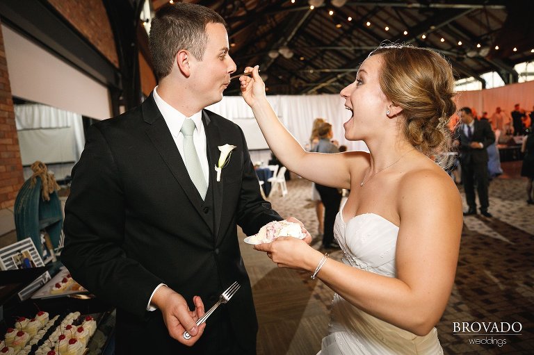 Bride feeding the groom wedding cake