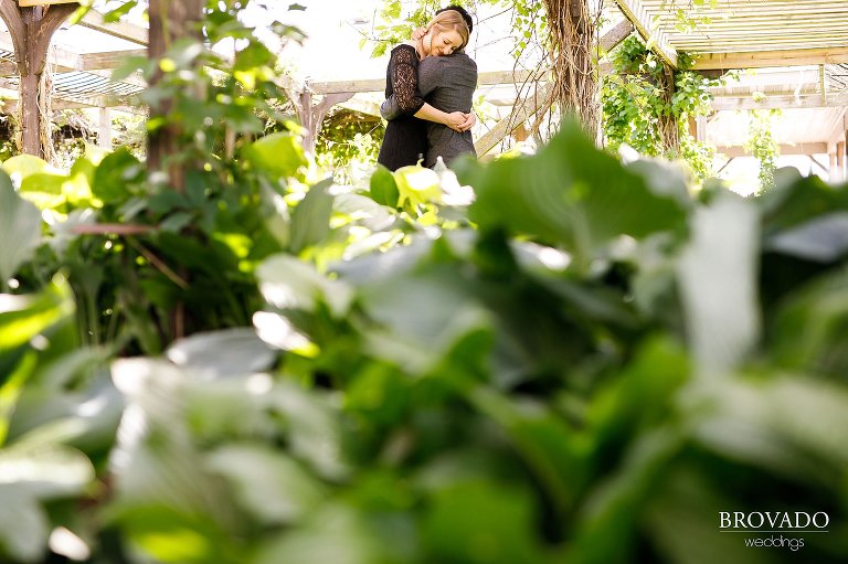 Ajit and Jenna hugging in greenhouse
