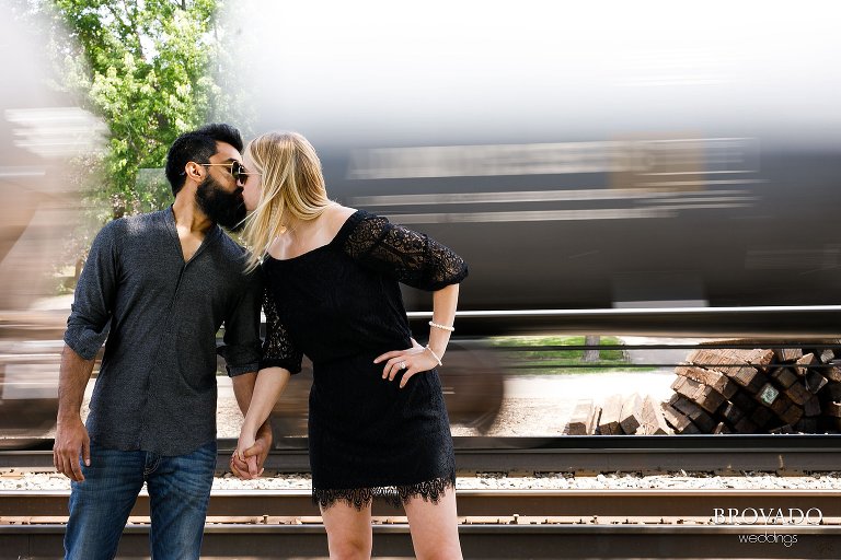 Ajit and Jenna kissing in front of a speeding train