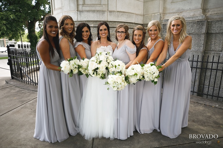 Laura and her bridesmaids showing off their bouquets