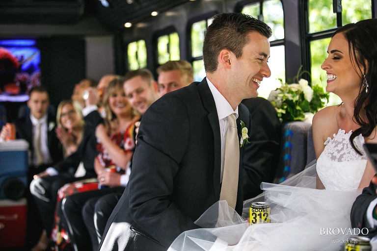 Bride and groom laughing with beers in their hands