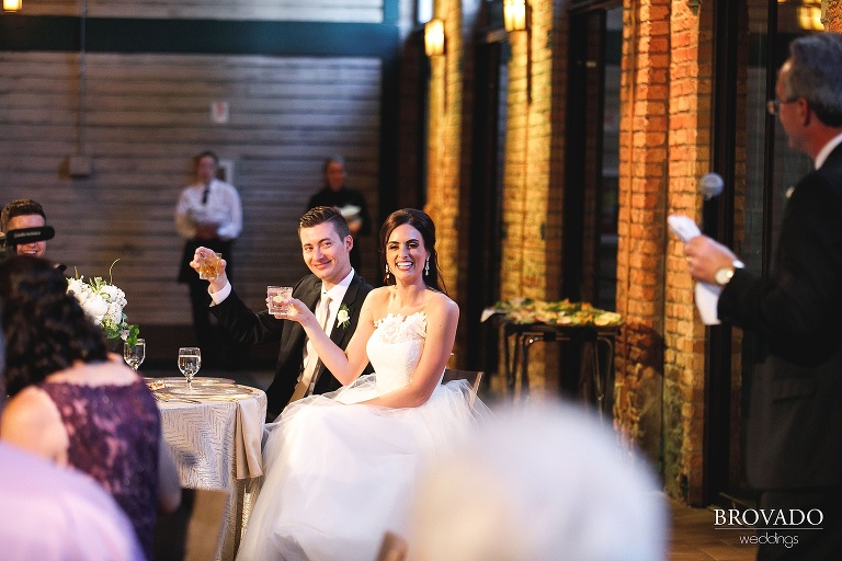 Bride and groom laughing during speech
