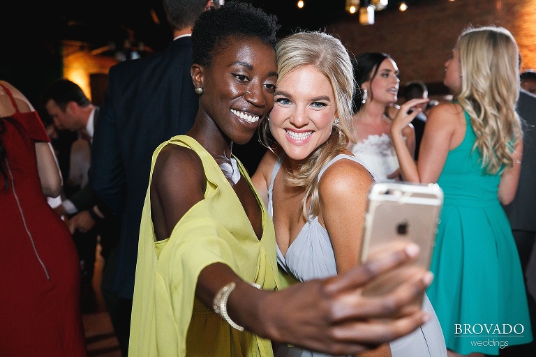 Bridesmaid and her friend taking a dancing selfie