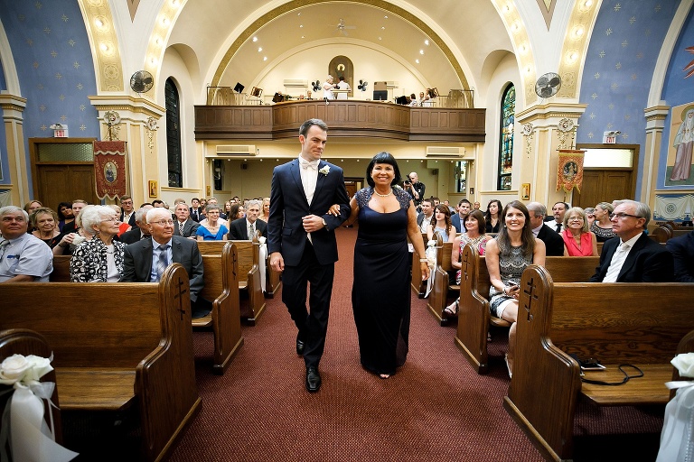 Nick and his mother walking down the aisle