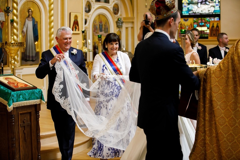 Bride's grandparents carrying her veil