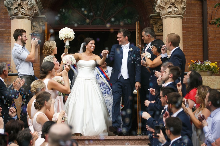 Bride and groom walking through bubbles