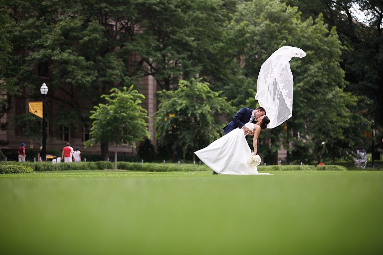 Bride being dipped with veil flying in the air