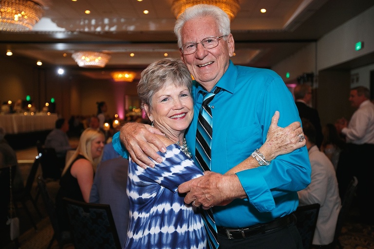 Elderly couple posing at wedding reception