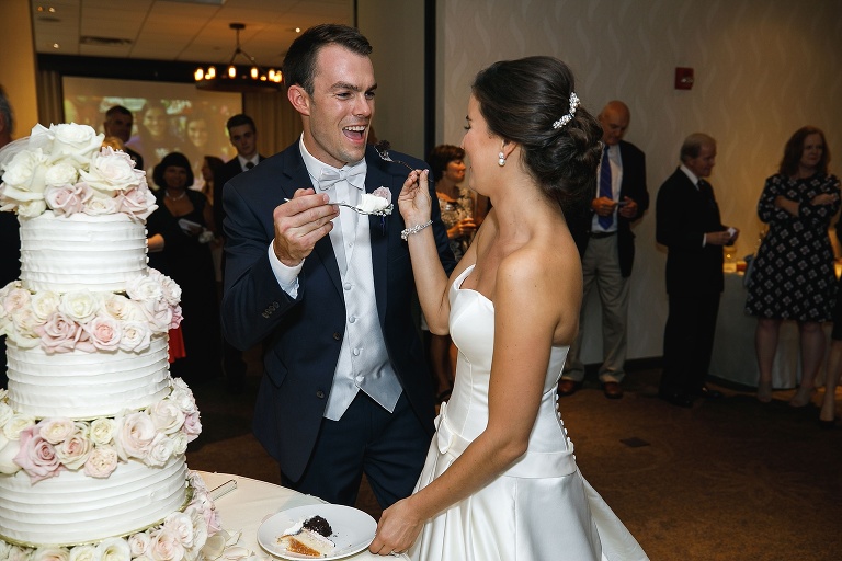 Bride and groom feeding each other cake