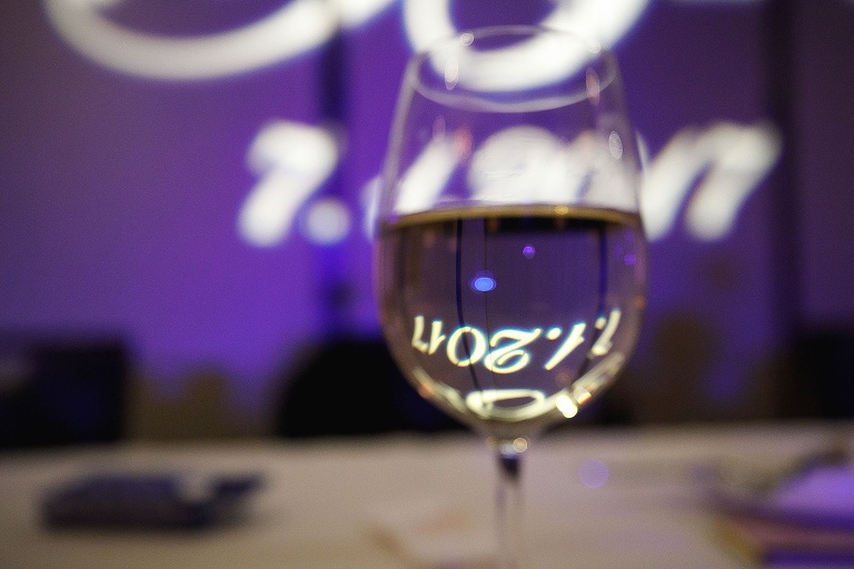 Wedding date reflected in wine glass