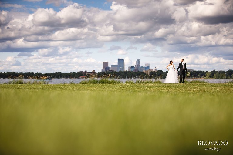 Laura and Michael posing in front of Minneapolis skyline