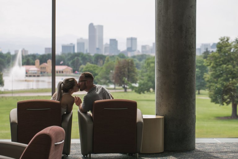 Zach and Coty kissing in front of Denver skyline