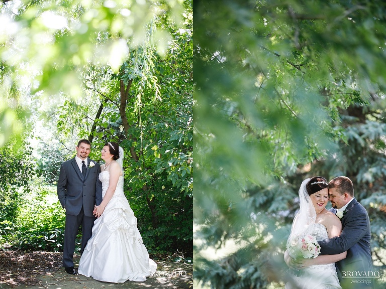 Bride and groom posing by minnesota trees