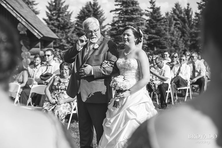 Father of the bride shedding a tear while walking down the aisle