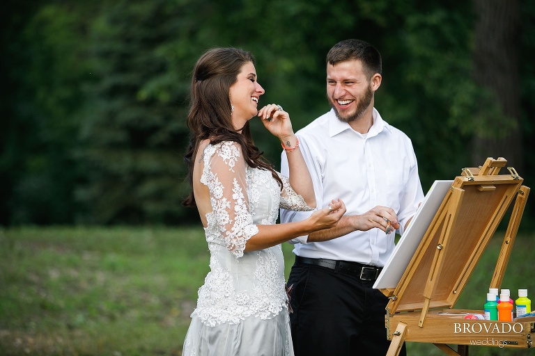 John and Nova laughing while painting