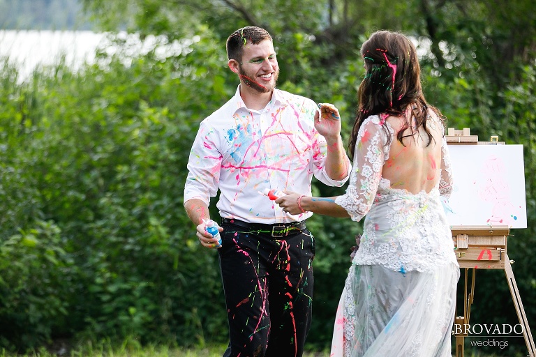 Smiling couple trashing wedding dress