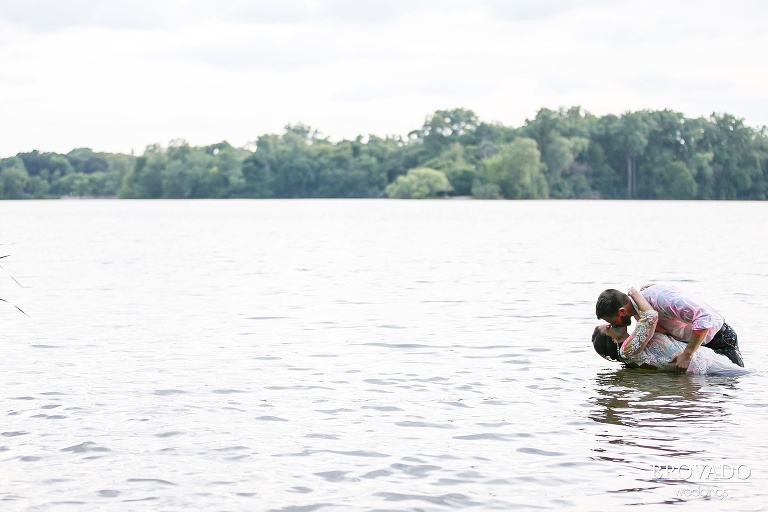 John dipping his wife in the lake