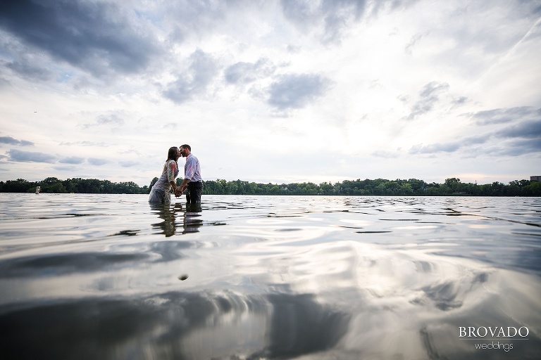 Married couple kissing in lake