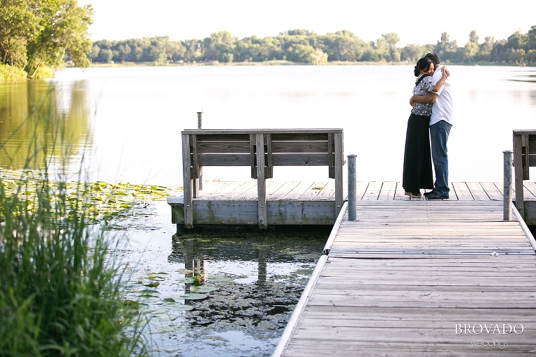 engaged couple embracing on lakeside