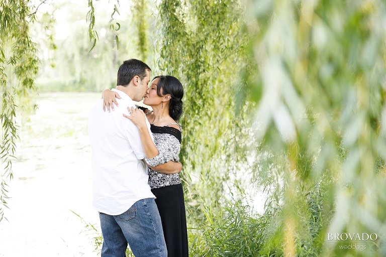 Christine and Nick kissing among willow trees