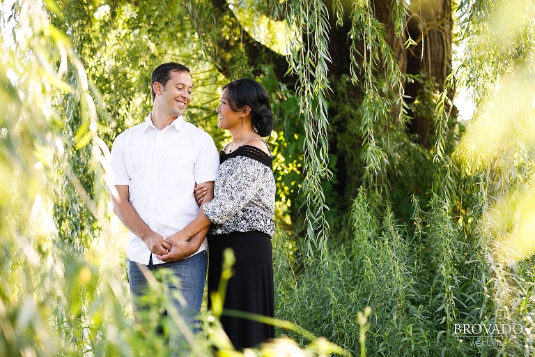Engaged couple embracing by Minnesota lake