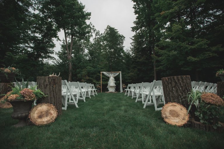 Coty's layered wedding dress hanging from wedding archway