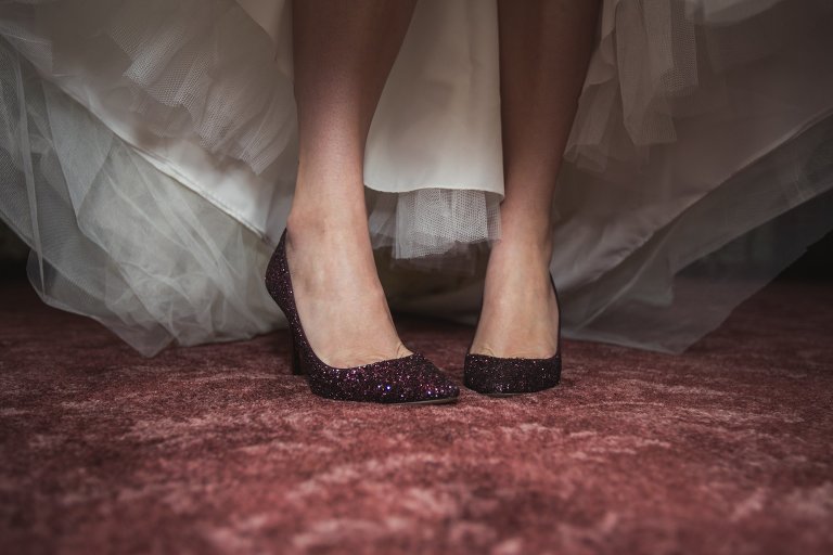 Coty showing off red jimmy choo wedding heels