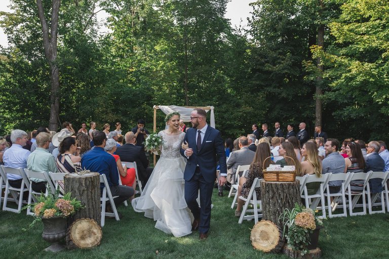Zach and Coty walking down the aisle arm in arm