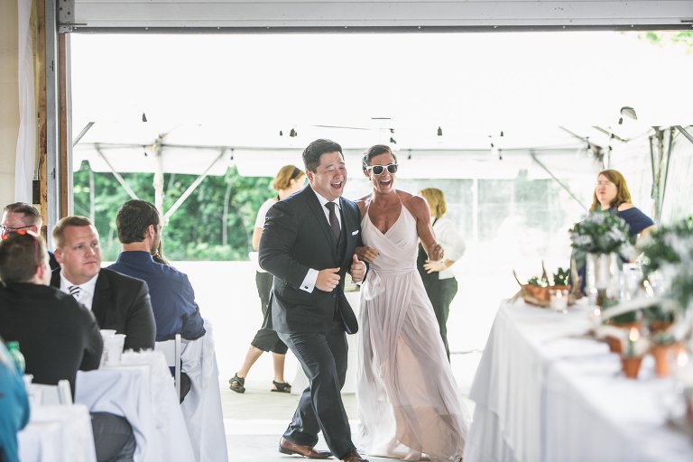 Wedding party dancing into reception