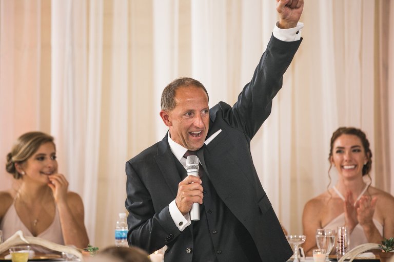 Father of the bride leading toast and blessing at reception