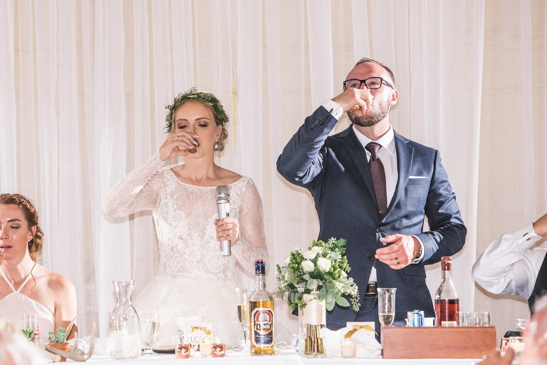 Bride and groom taking a shot